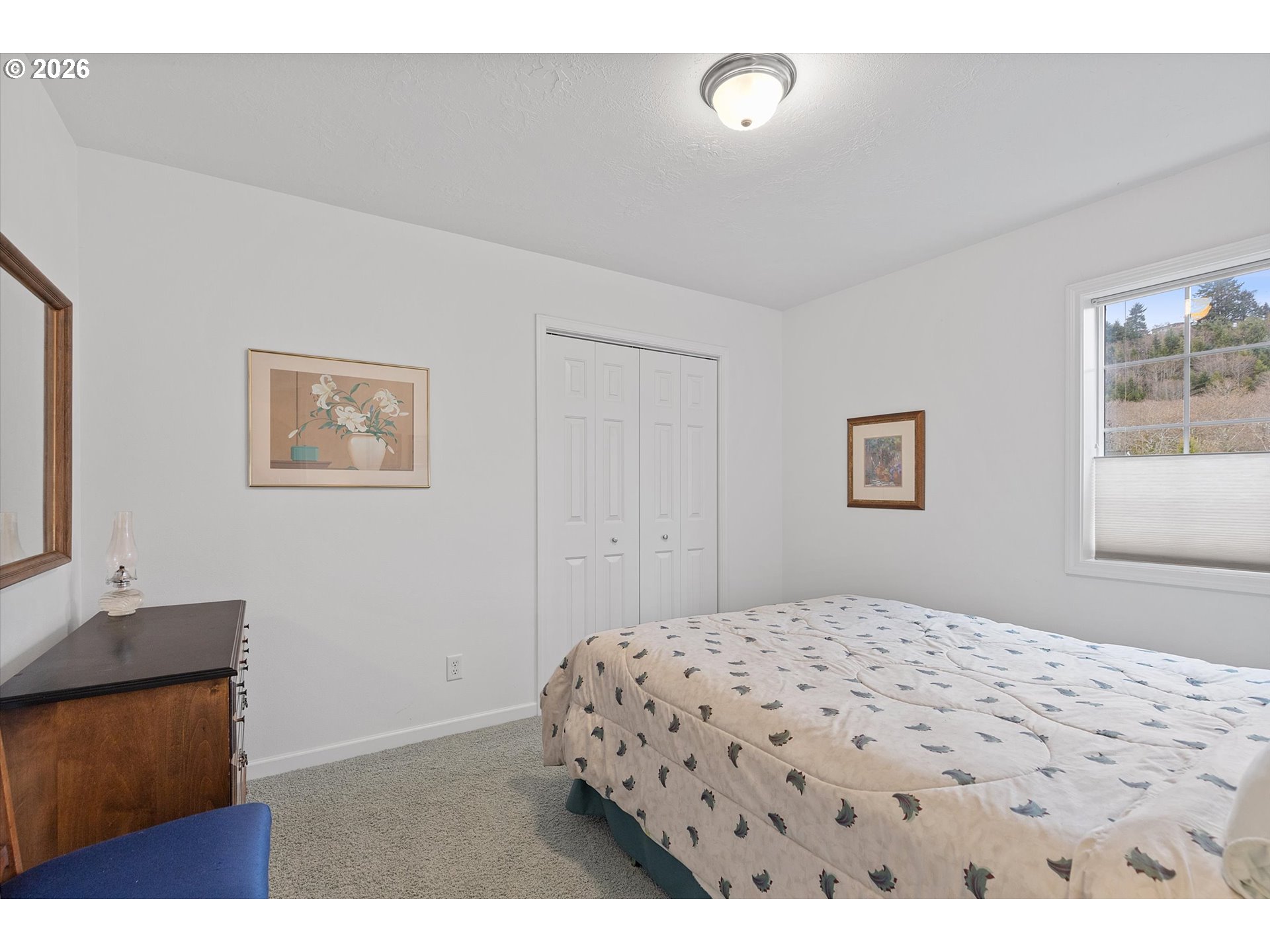49800 Proposal Rock Loop Neskowin, OR 97149 - Photo 21 of 29 a bedroom with a bed and a dresser with rug