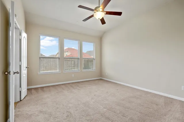 a view of room with window and ceiling fan