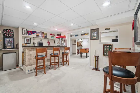 a dining room with furniture and a kitchen view