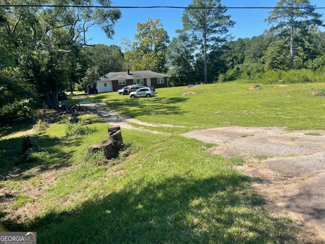 a view of a table and chairs in the garden