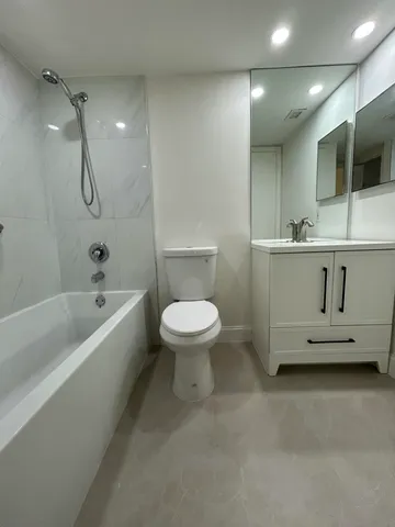 a bathroom with a sink a toilet and a bathtub
