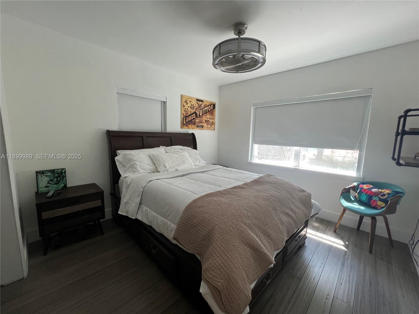 3680 Southwest 13th Terrace Miami, FL 33145 - Photo 15 of 18 a bedroom with a bed and a chandelier