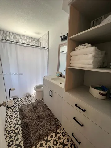 a view of a room with wooden floor and windows