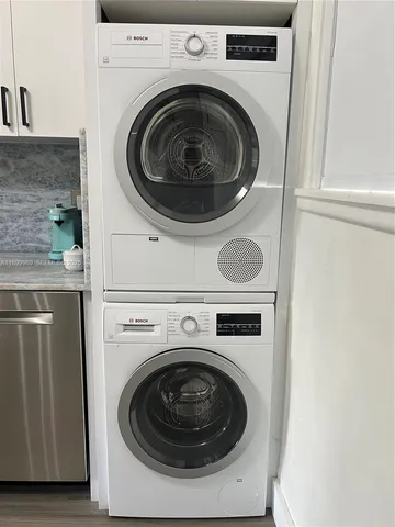 a utility room with sink dryer and washer