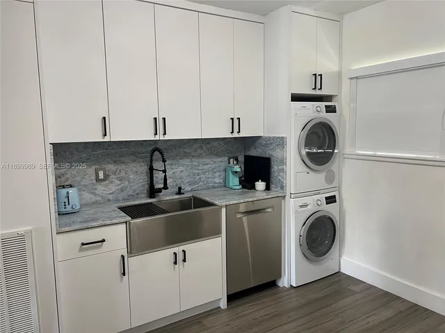 a kitchen with white cabinets and white appliances