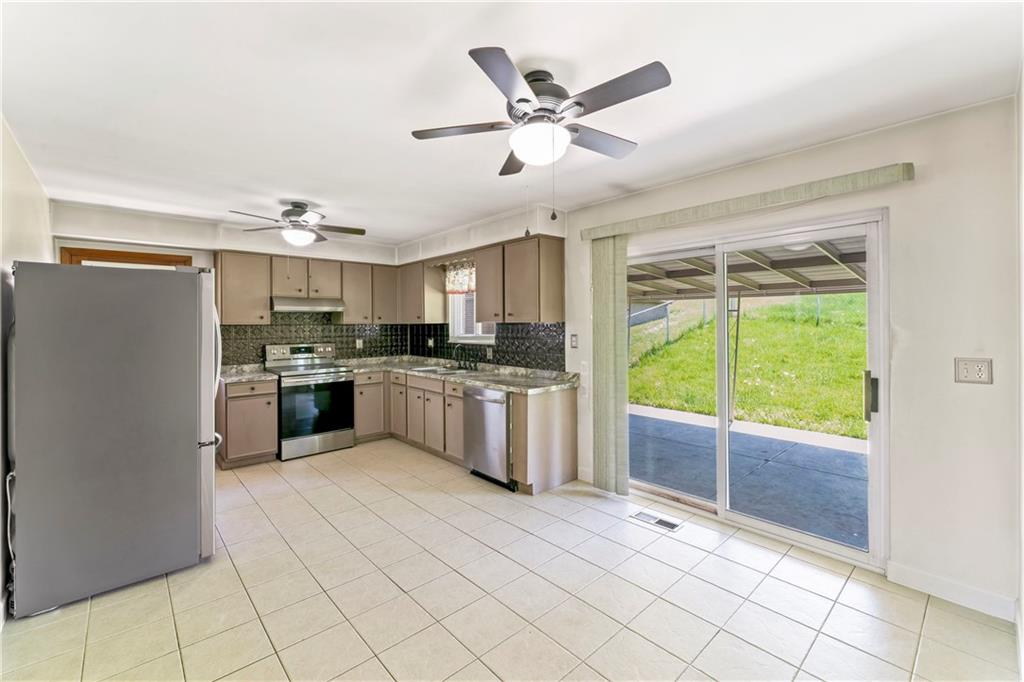 210 Springfield Avenue Washington, PA 15301 - Photo 11 of 28 a kitchen with a stove a sink and a refrigerator