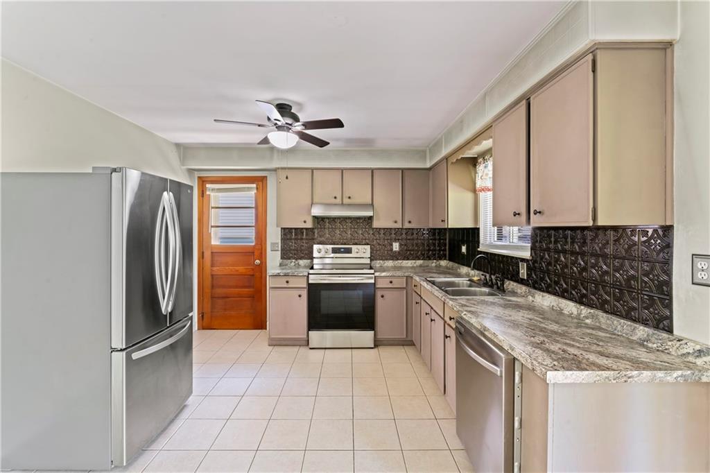 210 Springfield Avenue Washington, PA 15301 - Photo 12 of 28 a kitchen with a stove a refrigerator and a sink