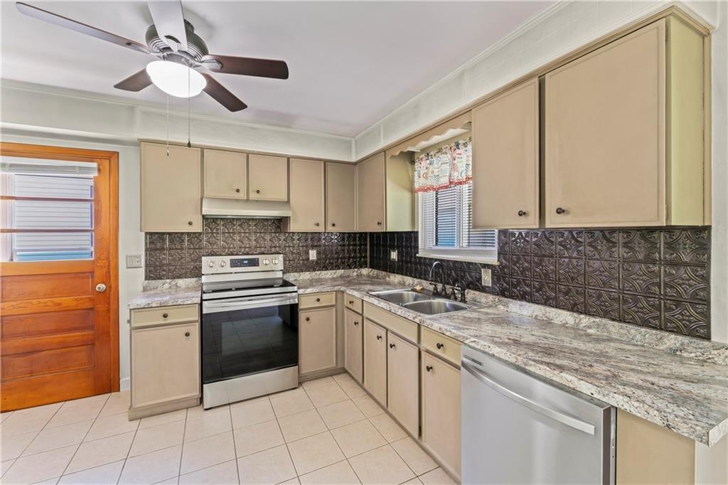 210 Springfield Avenue Washington, PA 15301 - Photo 13 of 28 a kitchen with a stove sink and cabinets