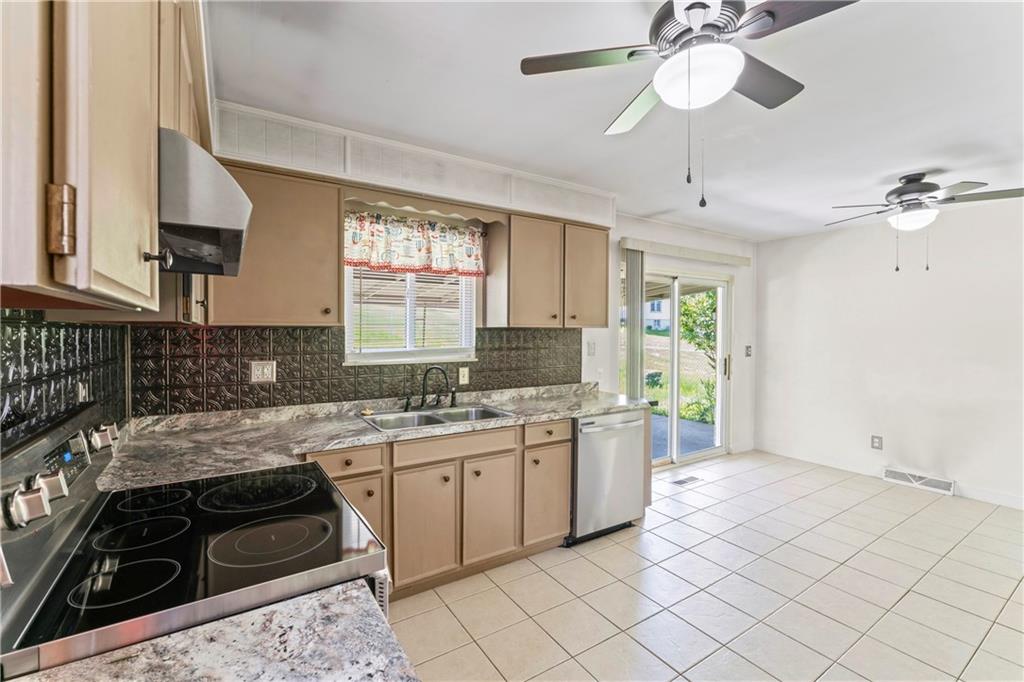 210 Springfield Avenue Washington, PA 15301 - Photo 14 of 28 a kitchen with a sink stove and cabinets