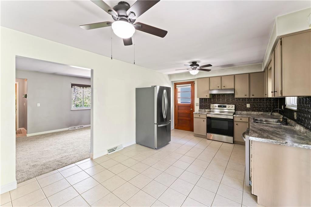 210 Springfield Avenue Washington, PA 15301 - Photo 15 of 28 a kitchen with stainless steel appliances granite countertop a refrigerator and a sink