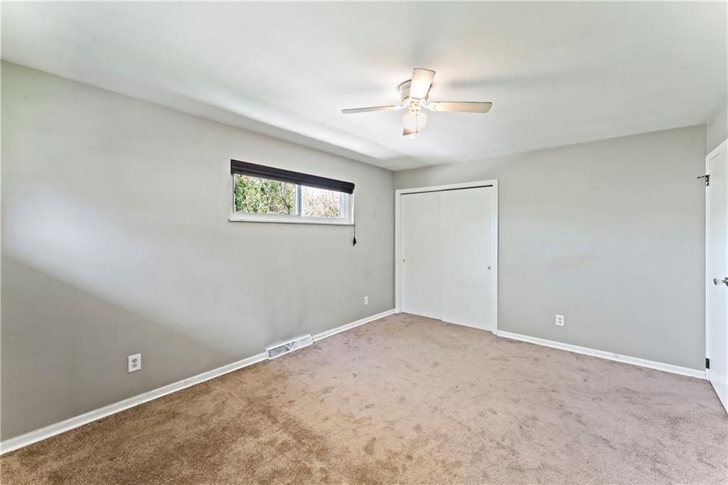 210 Springfield Avenue Washington, PA 15301 - Photo 18 of 28 an empty room with windows and fan