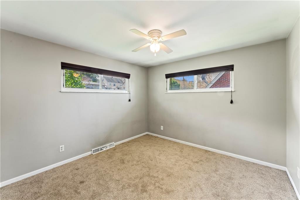 210 Springfield Avenue Washington, PA 15301 - Photo 20 of 28 an empty room with windows and ceiling fan