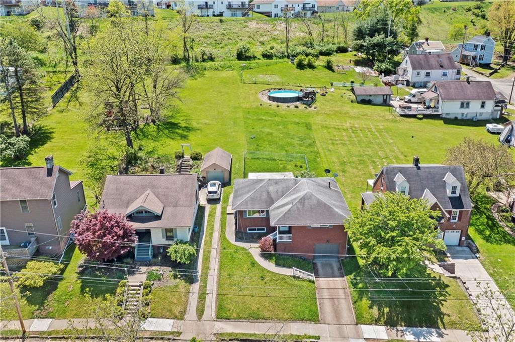 210 Springfield Avenue Washington, PA 15301 - Photo 3 of 28 an aerial view of residential houses with outdoor space and swimming pool