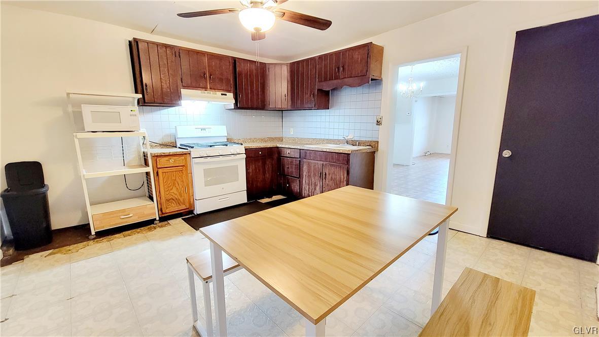1512 East 7th Street Bethlehem, PA 18015 - Photo 3 of 15 a kitchen with a refrigerator sink and stove