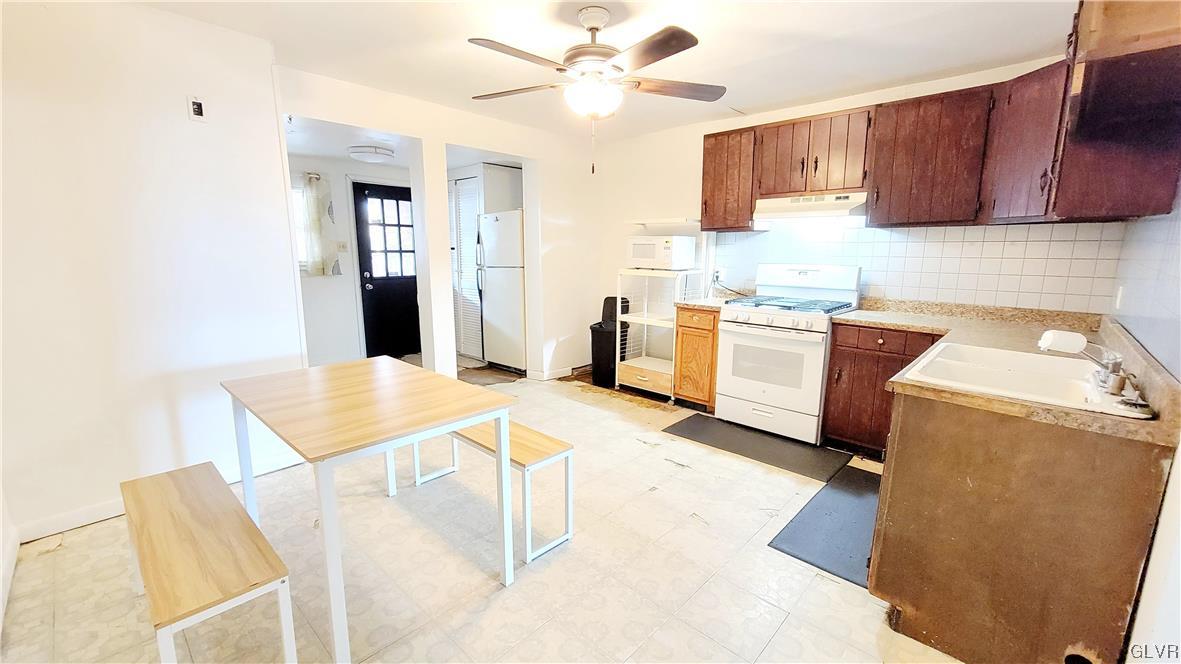 1512 East 7th Street Bethlehem, PA 18015 - Photo 4 of 15 a kitchen with a stove a refrigerator and a sink