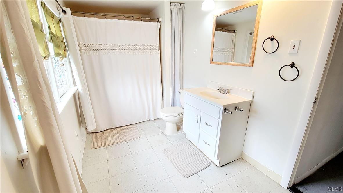 1512 East 7th Street Bethlehem, PA 18015 - Photo 5 of 15 a bathroom with a sink a toilet and a mirror