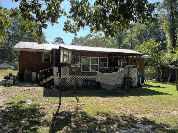a view of a house with backyard porch and sitting area