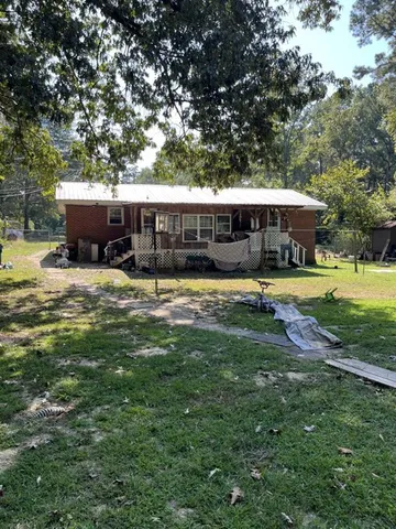 a view of a house with swimming pool and yard