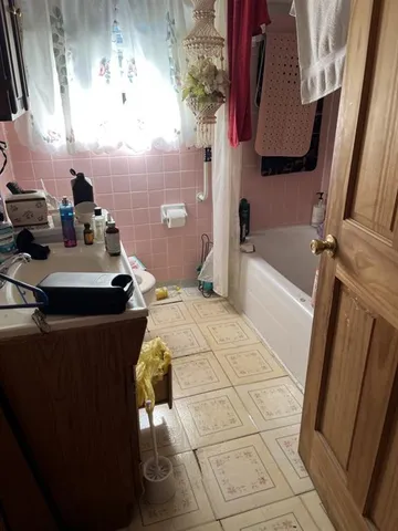 a bathroom with a bathtub and shower