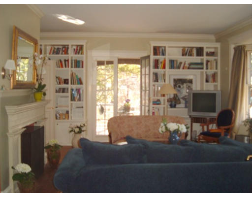 233 Clinton Road Brookline, MA 02445 - Photo 3 of 6 a living room with furniture wooden floor and a fireplace