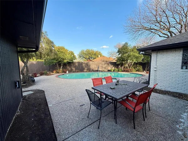 an outdoor view with swimming pool and trees