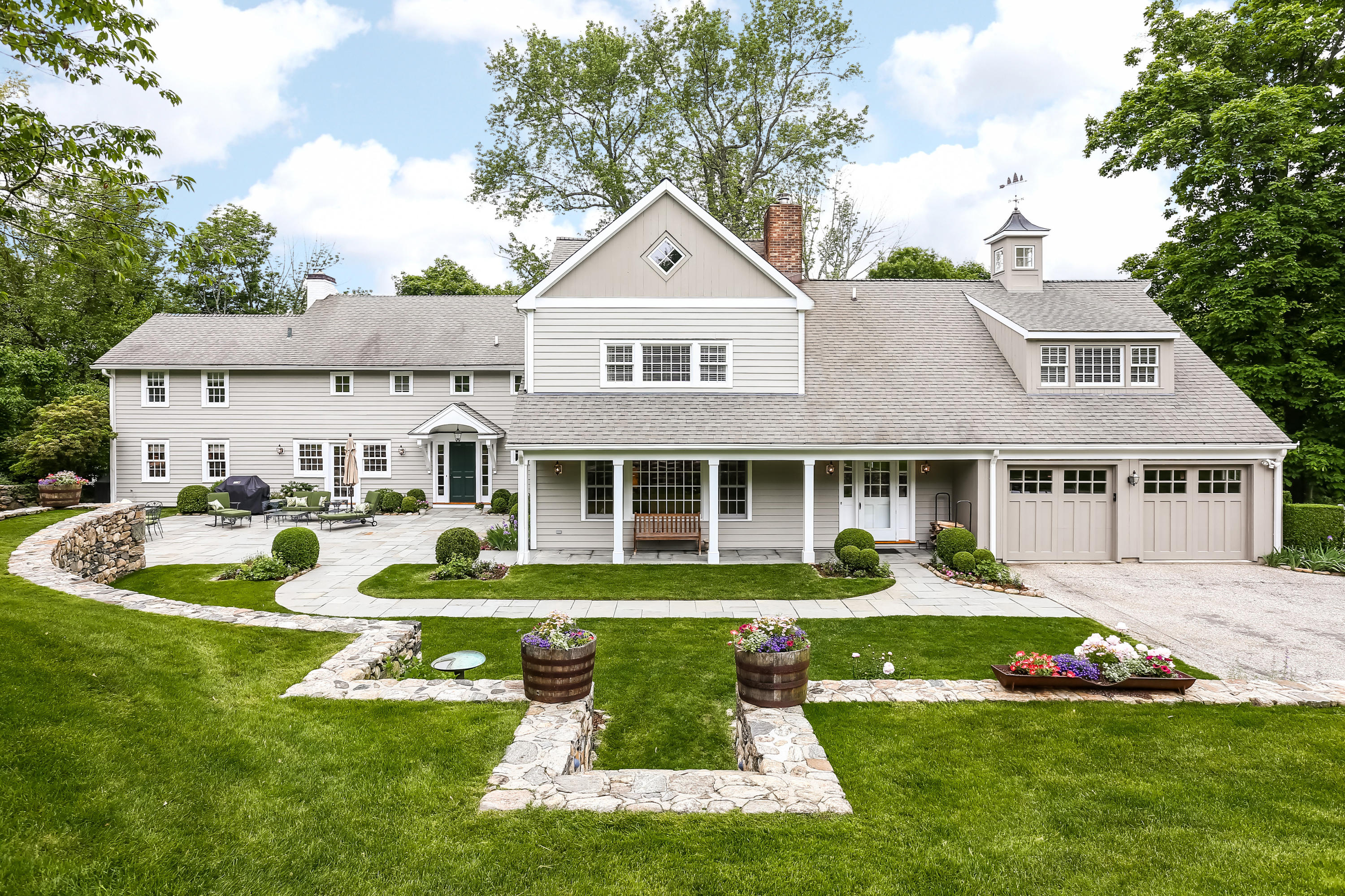 2 Saddle Ridge Road Darien, CT 06820 - Photo 1 of 33 a front view of a house with a yard table and chairs