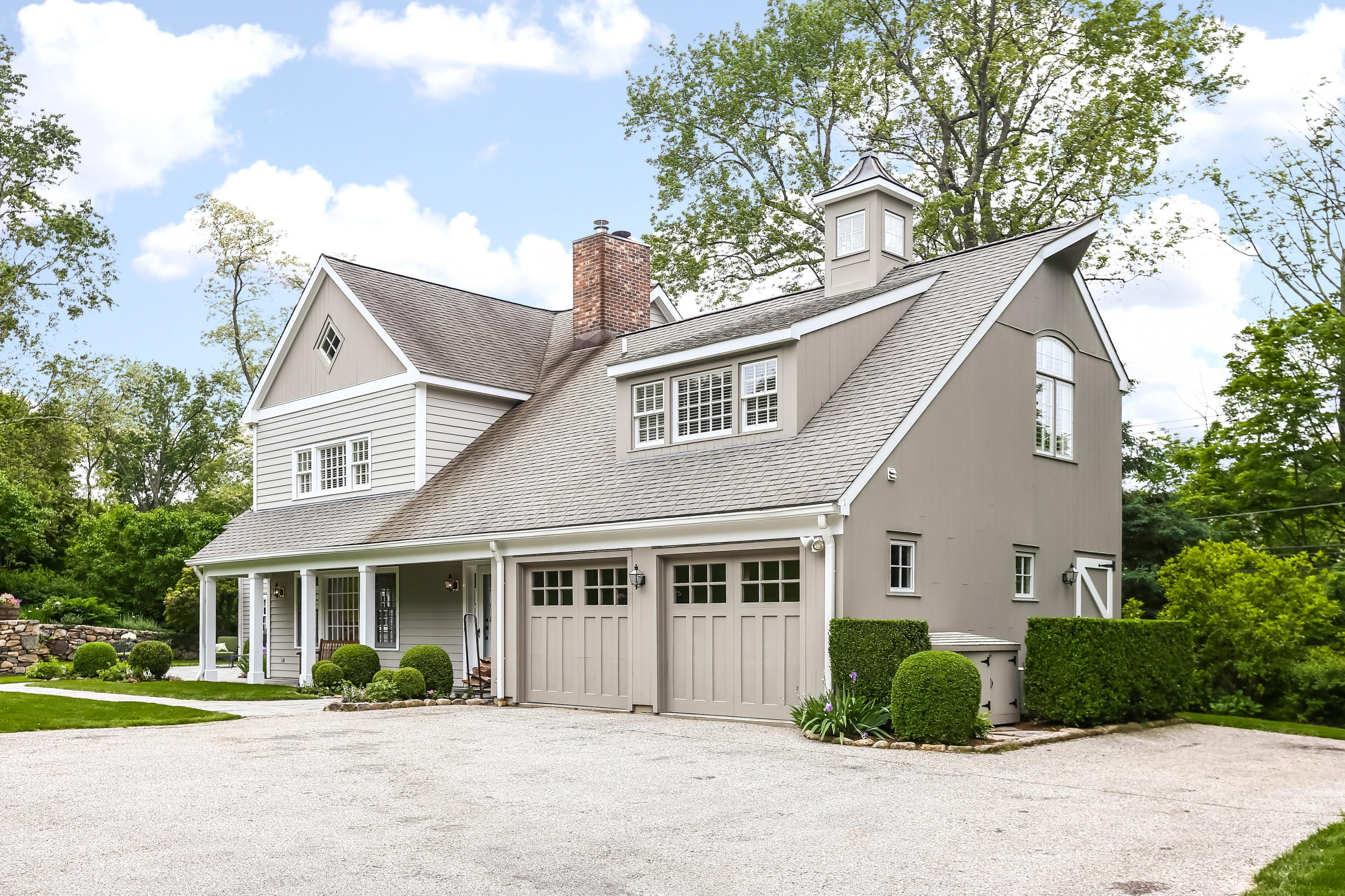 2 Saddle Ridge Road Darien, CT 06820 - Photo 6 of 33 a front view of a house with a garden