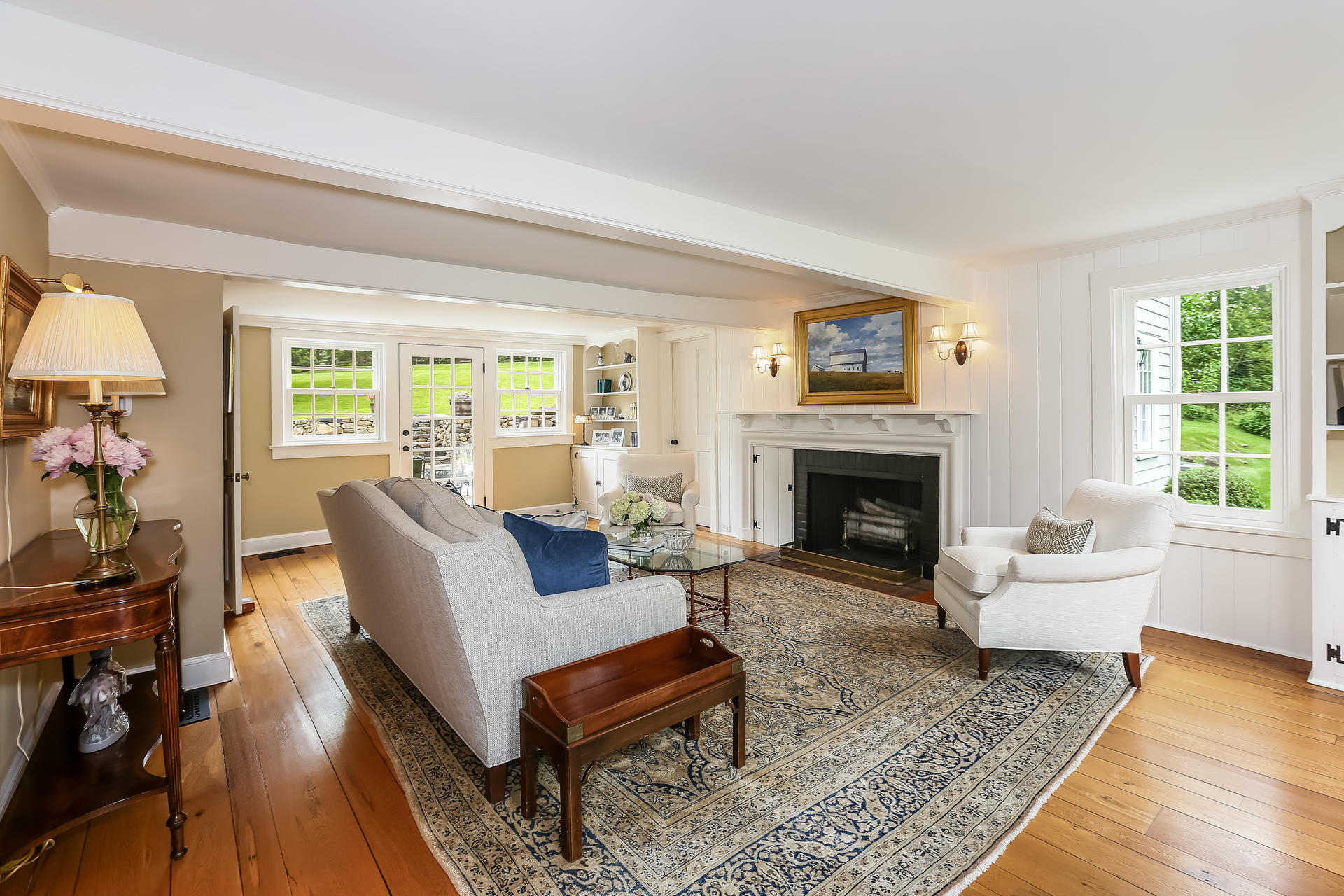 2 Saddle Ridge Road Darien, CT 06820 - Photo 8 of 33 a living room with furniture a rug a fireplace and a large window