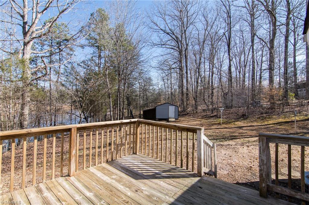 4819 Poplar Ridge Road Trinity, NC 27370 - Photo 3 of 22 Side deck with view of community pond and fenced in back yard.