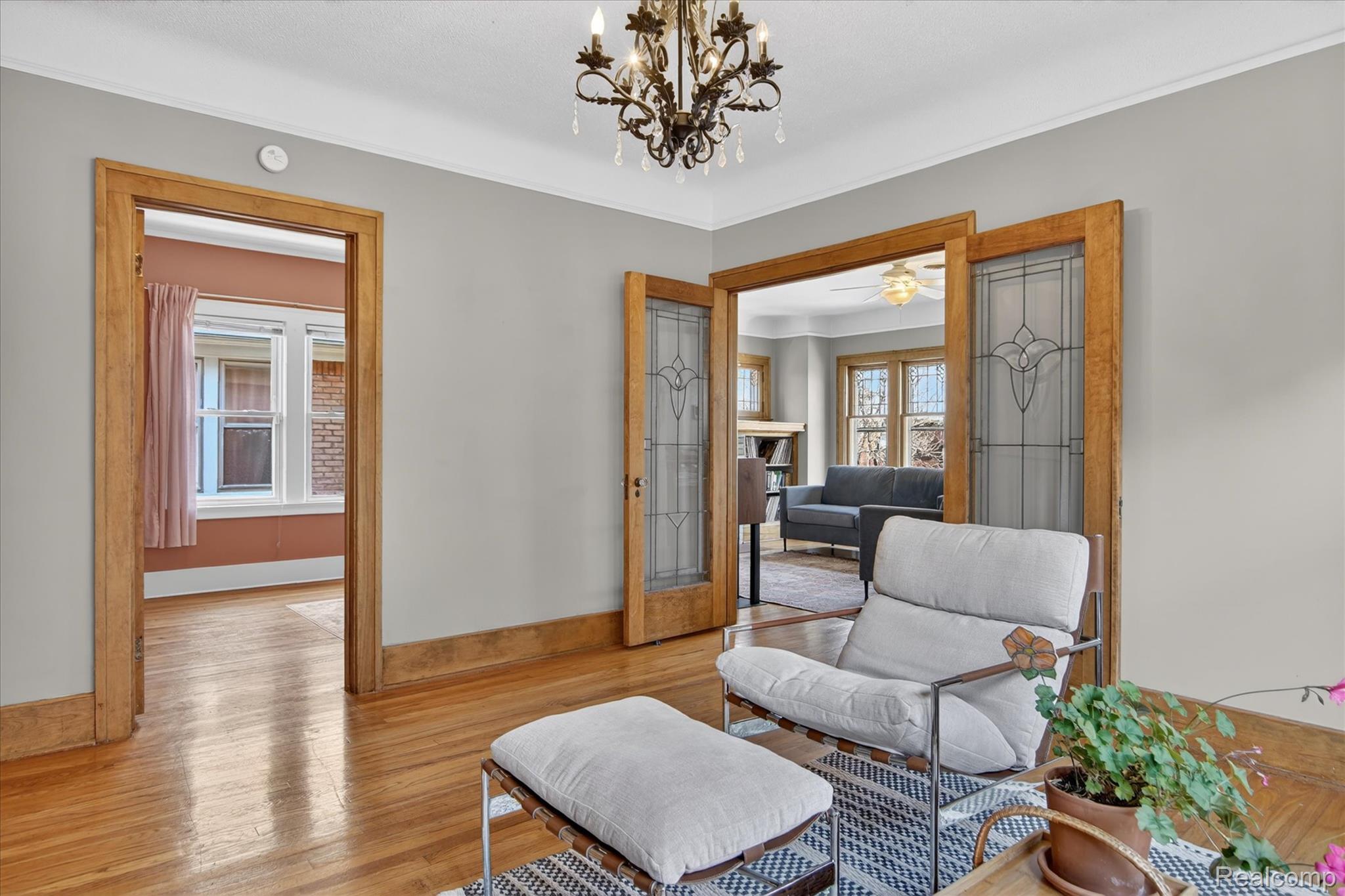 925 Nottingham Road Grosse Pointe, MI 48230 - Photo 16 of 46 Living area with hardwood / wood-style floors, suspended lighting, a fireplace, and ceiling fan