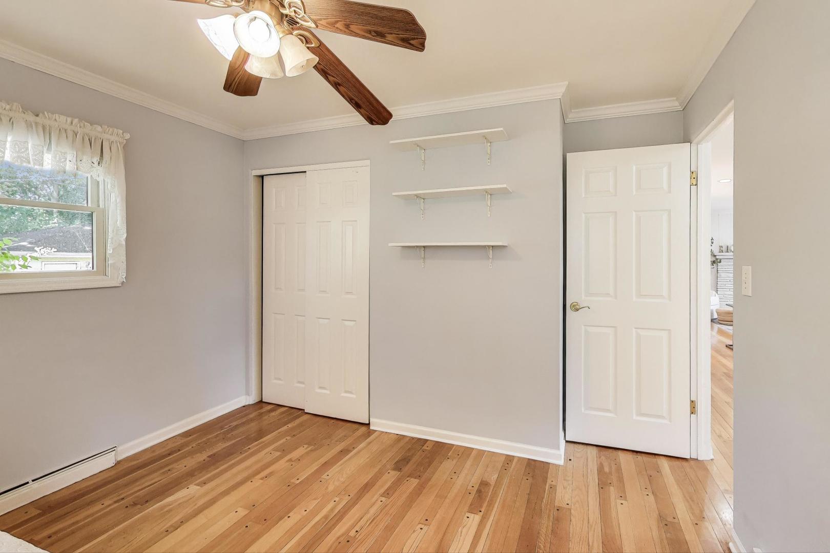 924 Lyford Lane Wheaton, IL 60189 - Photo 19 of 43 a view of an empty room with wooden floor and a window