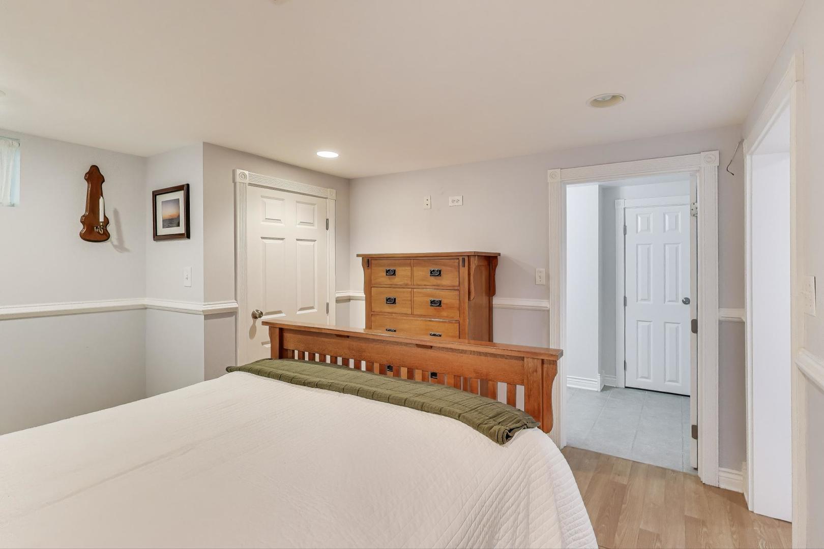 924 Lyford Lane Wheaton, IL 60189 - Photo 28 of 43 a bedroom with a bed and painting on the wall