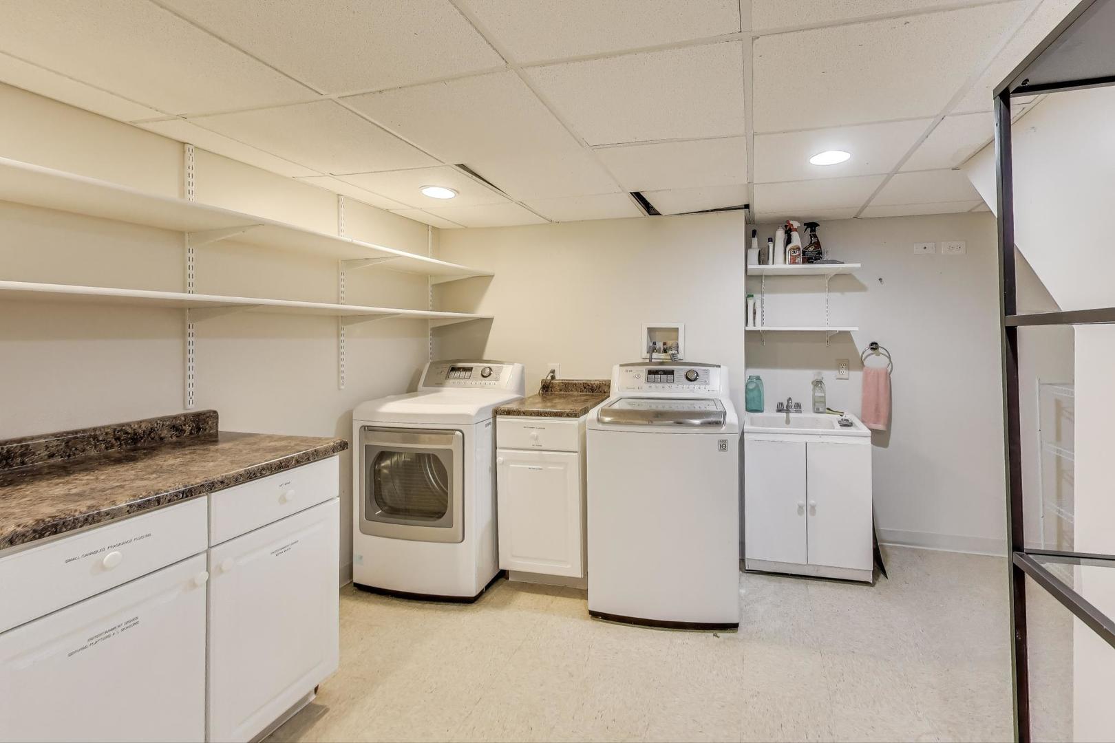 924 Lyford Lane Wheaton, IL 60189 - Photo 31 of 43 a utility room with cabinets washer and dryer