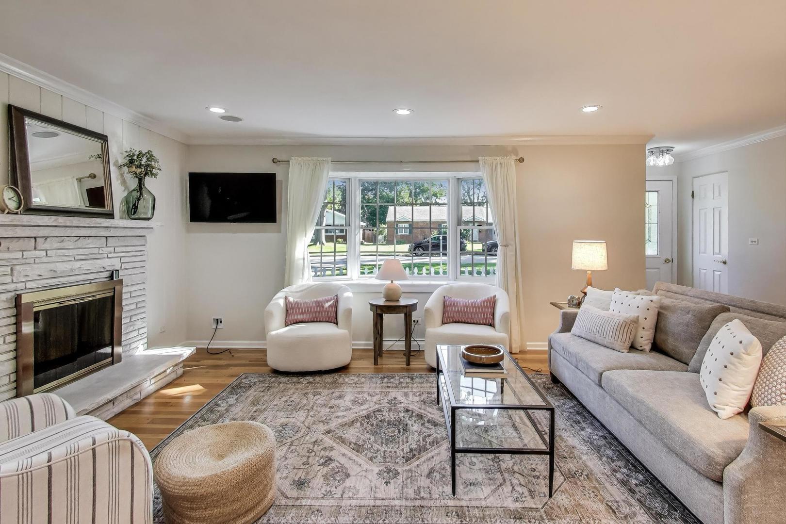 924 Lyford Lane Wheaton, IL 60189 - Photo 8 of 43 a living room with furniture or fireplace and a flat screen tv