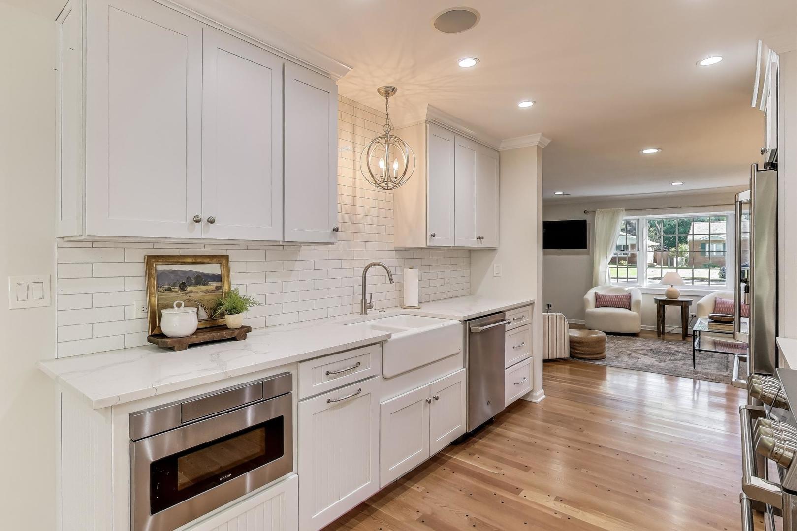924 Lyford Lane Wheaton, IL 60189 - Photo 10 of 43 a kitchen with a sink dishwasher white cabinets and white appliances