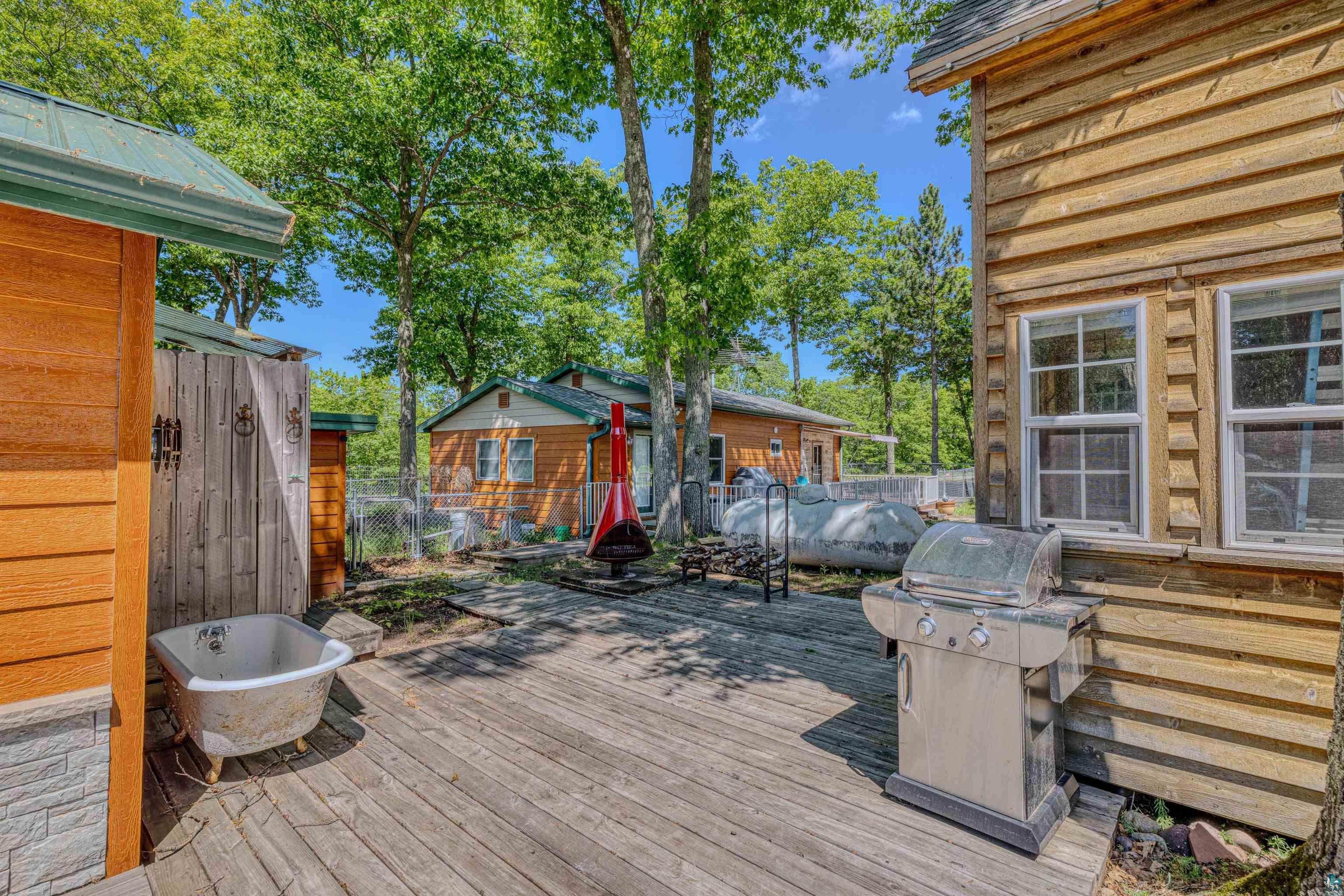 66075 Rooster Road Iron River, WI 54847 - Photo 33 of 52 Expansive wood-finish deck with surrounding mature trees