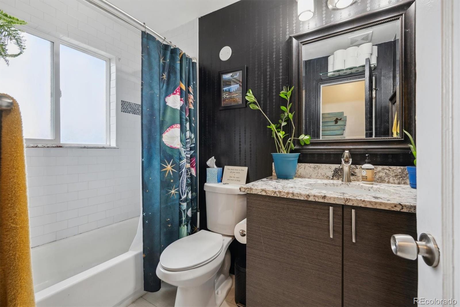 2870 Pontiac Street Denver, CO 80207 - Photo 14 of 23 a bathroom with a granite countertop sink toilet and mirror