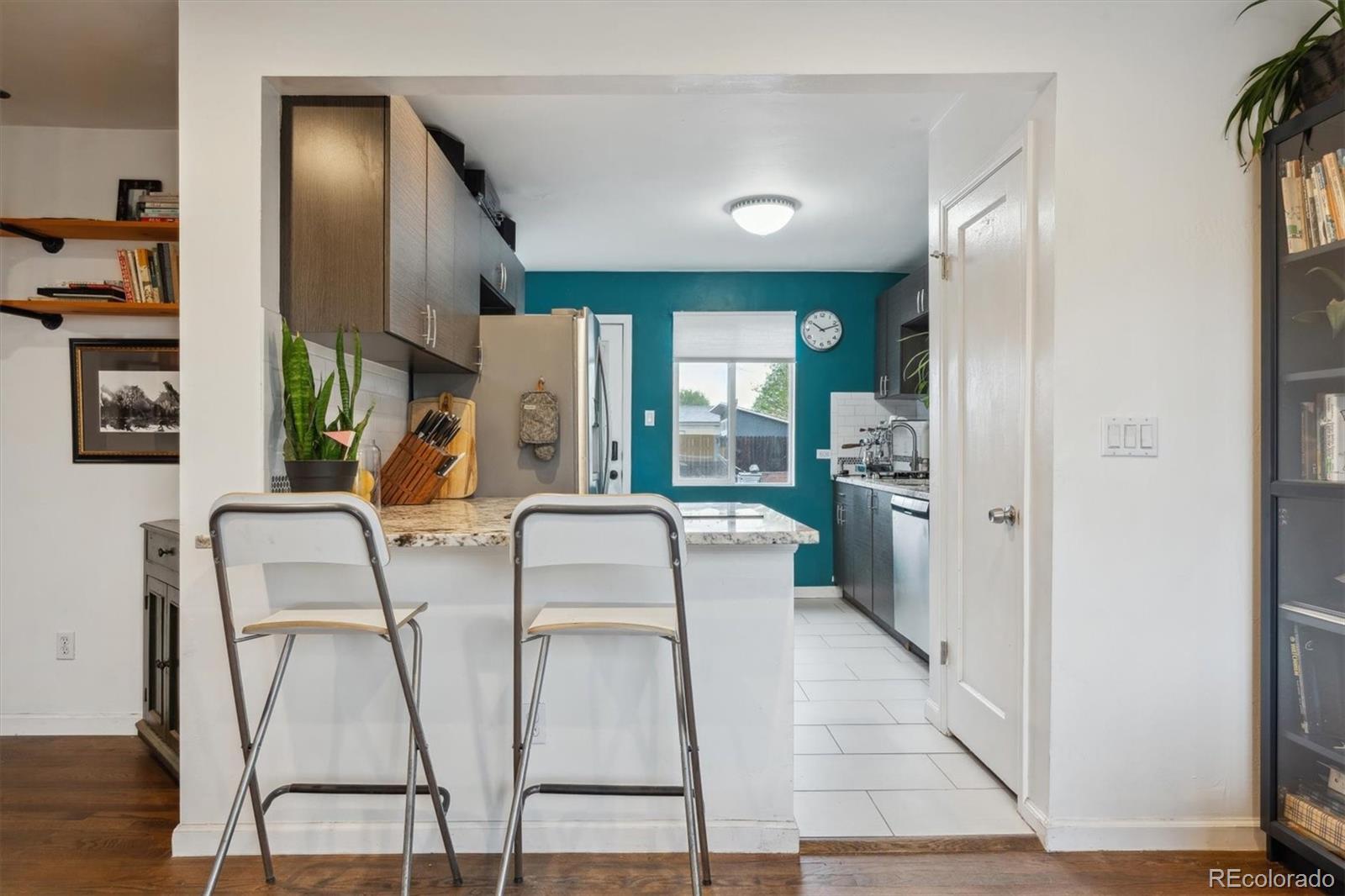 2870 Pontiac Street Denver, CO 80207 - Photo 8 of 23 a dining room with furniture and wooden floor