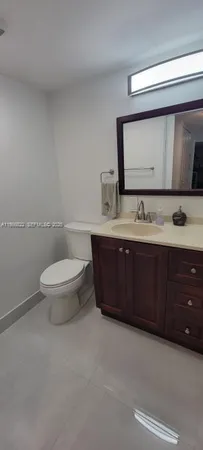 a view of a chandelier fan and fire place