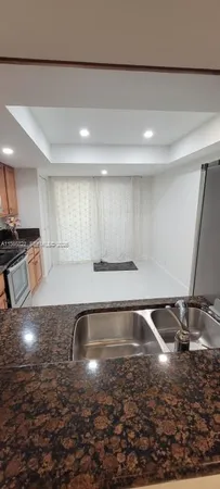a view of a kitchen with a sink and a stove top oven