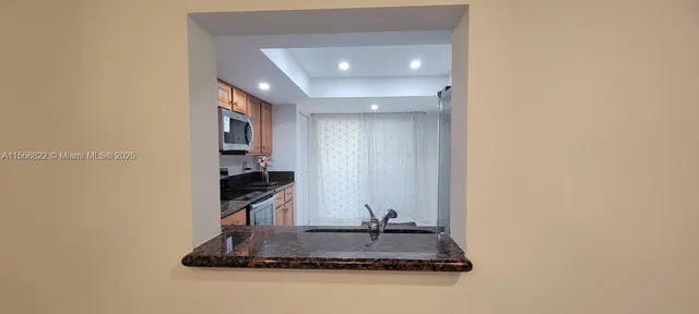 a kitchen with a refrigerator and a stove