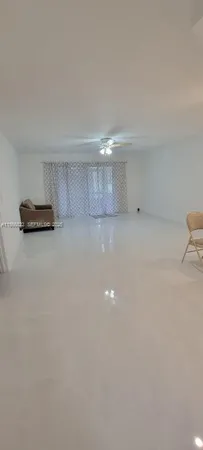 a view of a livingroom with a chandelier fan