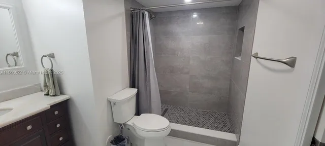 a bathroom with a shower and a toilet