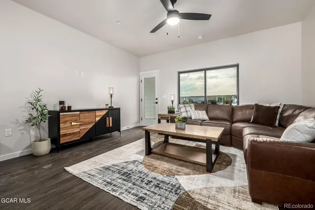 a living room with furniture and wooden floor