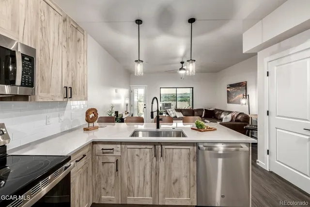 a kitchen with a sink stove and cabinets