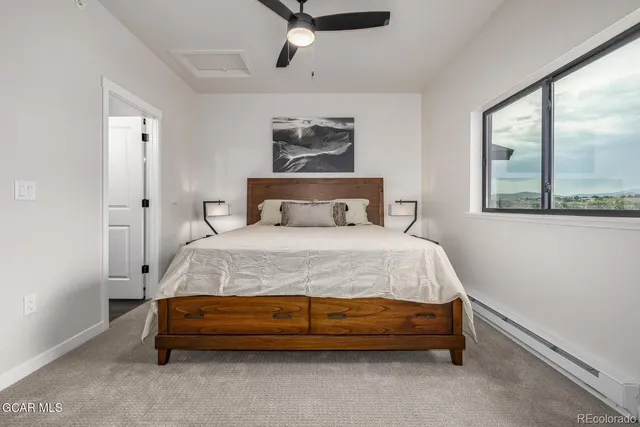 a bed sitting in a bedroom next to a window