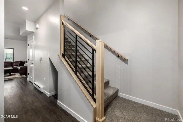 a view of an entryway with wooden floor