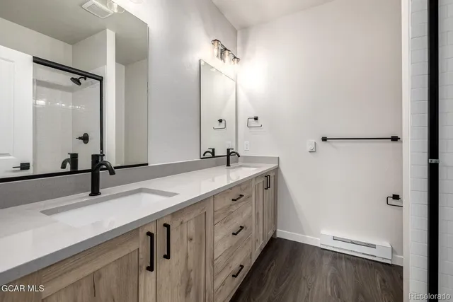 a spacious bathroom with a granite countertop sink and a mirror