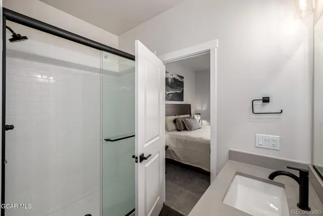 a en suite bathroom with a sink and a mirror