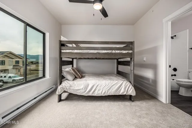 a room with a bed and large window